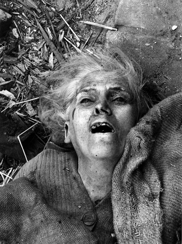 A woman killed in the bombing of her apartment building during the German Siege of Warsaw in September 1939. Known to many as, “The face of suffering Poland,” this photo was taken by American Julien Bryan.