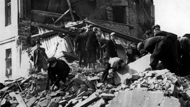 Residents of Warsaw search for the bodies of their neighbors in the rubble of an apartment building destroyed by a German bombing raid in September 1939.