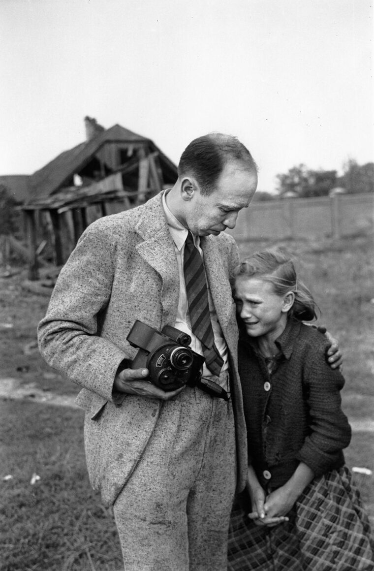 Filmmaker Julien Bryan comforts Kazimiera Kostewicz, 12, who has just seen her older sister machine-gunned to death in a potato field in Warsaw in September 1939. When Bryan returned to Poland in 1958, the pair posed for a similar photo.