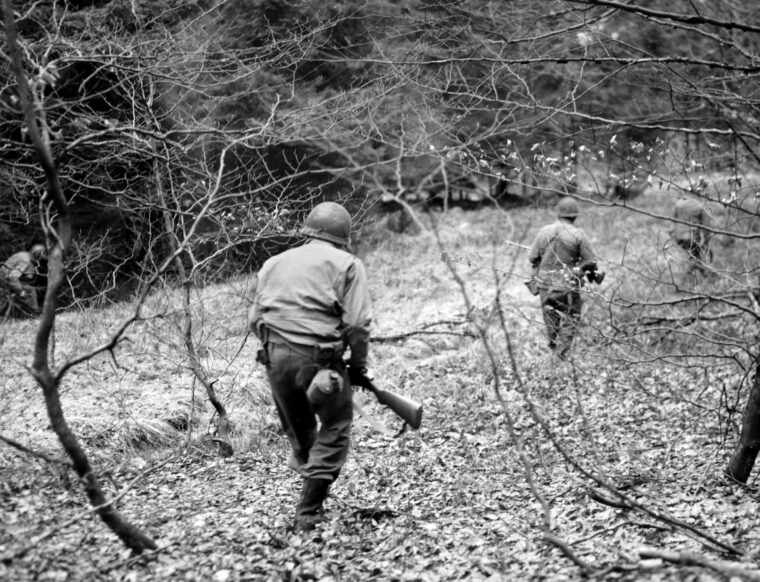 On December 18, 1944, a patrol from the U.S. 1st Infantry Division (Company F, 3rd Bn., 18th IR) searches for Fallschirmjäger that were dropped between Eupen and Bütgenbach, Belgium.​ The “Big Red One” held out against the German 6th Panzer Army on the shoulder of the “Bulge” from December 17 until January 28, 1945.