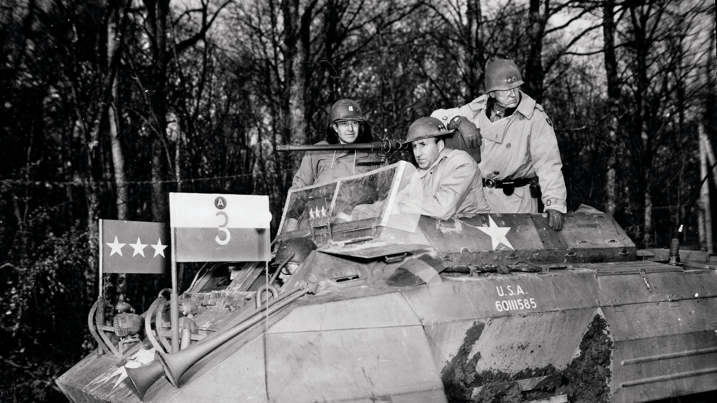 As the U.S. Third Army fights its way from the Saar River to the German border, Lt. Gen. George Patton takes ambassador to the Soviet Union Averell Harriman on a tour of the front in his personal modified M20 armored scout car. From left are British Lt. Col. James Gault (Eisenhower’s aide-de-camp), Harriman, and Patton.