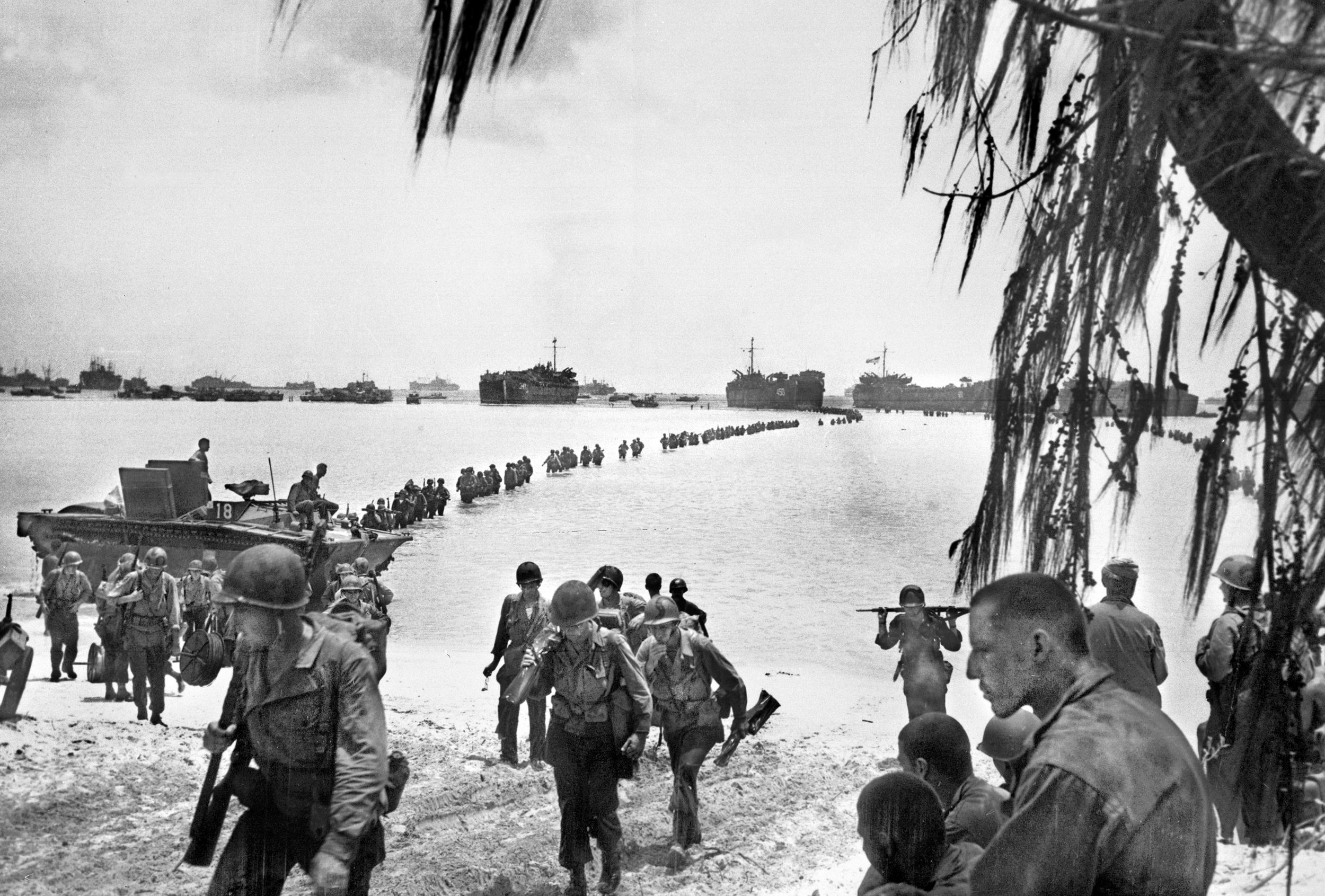 Troops from the 27th Infantry Division, a National Guard unit before the war, wade ashore on June 16, the second day of the invasion of Saipan. Launched just nine days after the Allied invasion of Europe, Operation Forager (June 15-July 9, 1944) was the largest amphibious assault in the Pacific Theater before Okinawa in 1945. Capturing Saipan, Tinian and Guam, would allow the U.S. to build air bases for the Army Air Corps’ long range B-29 Superfortress bombers to reach the Japanese home islands, including Tokyo.
