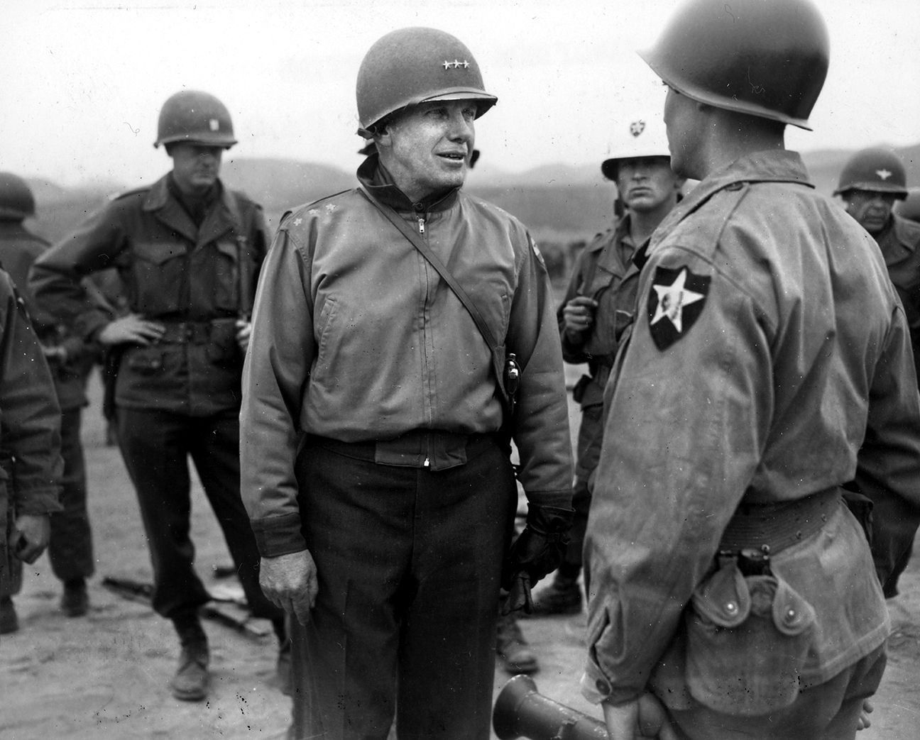 From left, X Corps commander Maj. Gen. Edward Almond talks with a soldier from the 2nd Infantry Division. 