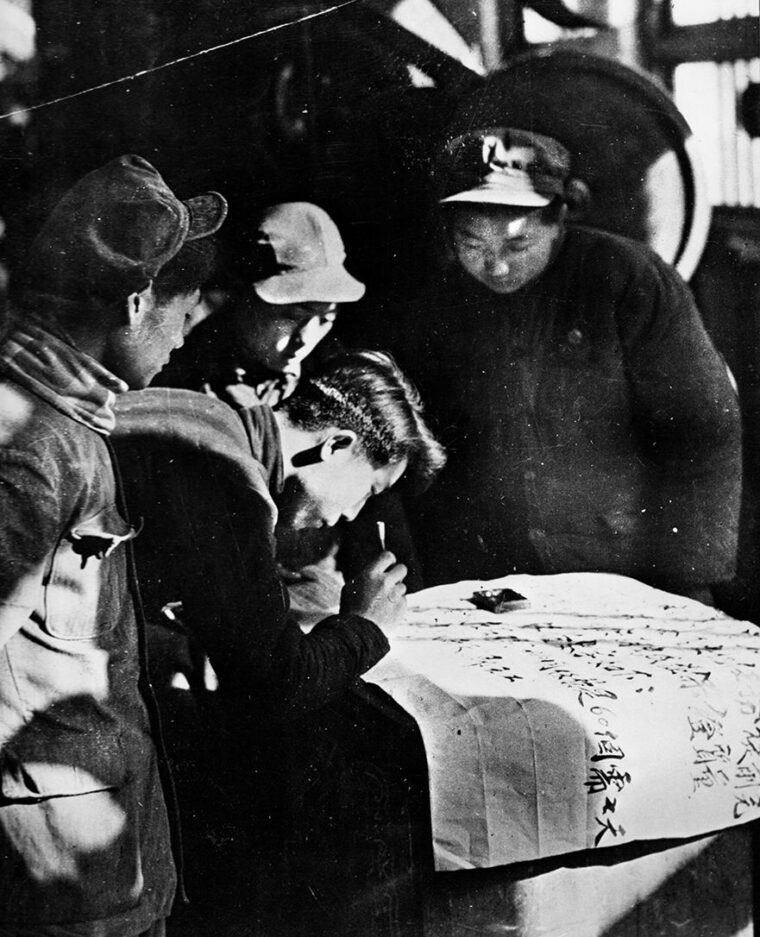 Enthusiastic Chinese volunteers working in a machine factory sign up for military service. About three million military and civilian personnel served in Korea as part of the Chinese People’s Volunteer Army. 