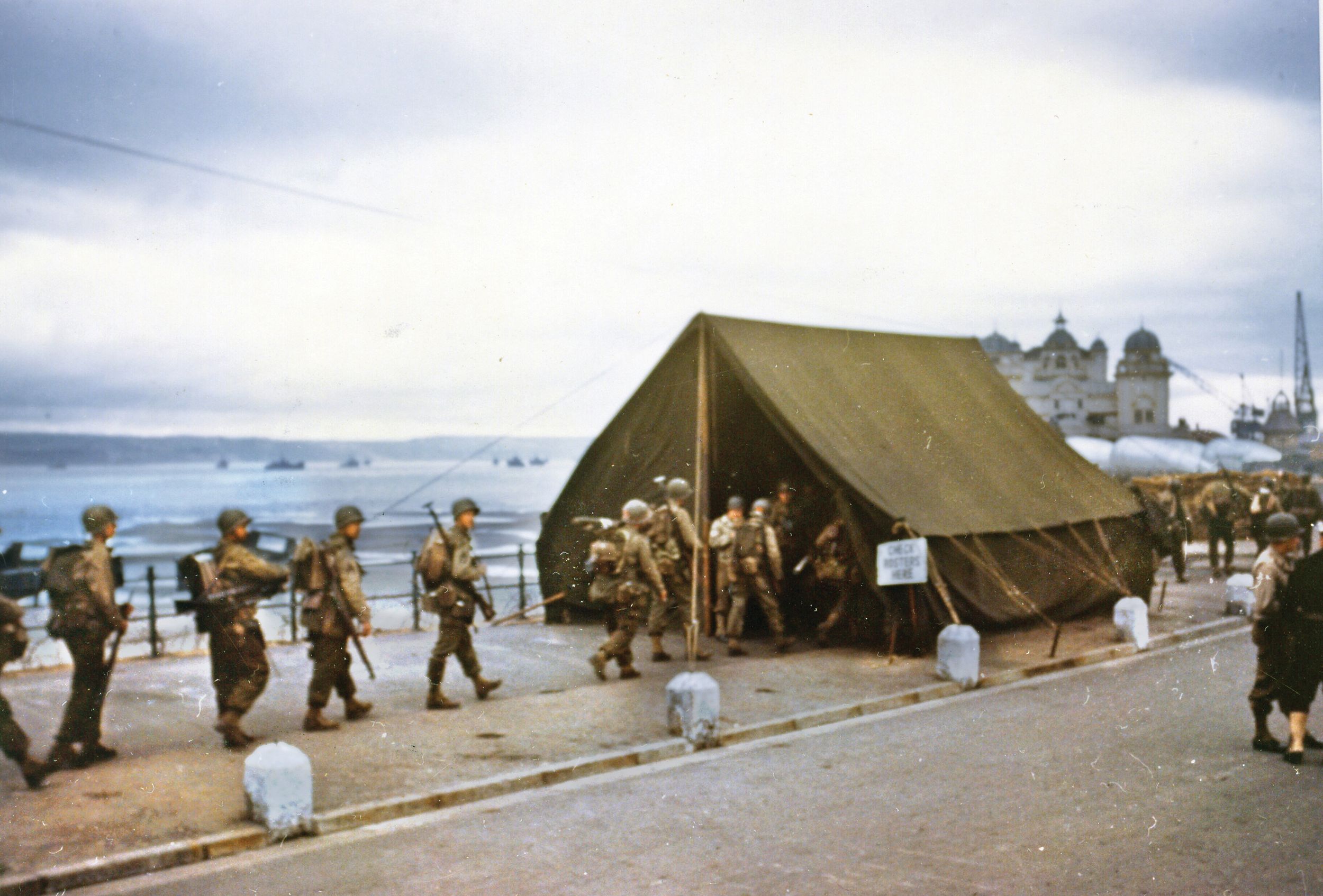 Soldiers pass through a roll call tent before boarding ships for the D-Day landing. Roy Stevens and his twin brother, Ray, would be on separate boats. Convinced he would not survive, Ray wanted to shake hands, but Roy refused, saying they would “shake hands on shore, when we got to Vierville. I wish now I had shaken his hand.” Of the 35 Bedford Boys that landed on D-Day, 21 died the first day, 19 of them within the first 15 minutes. 
