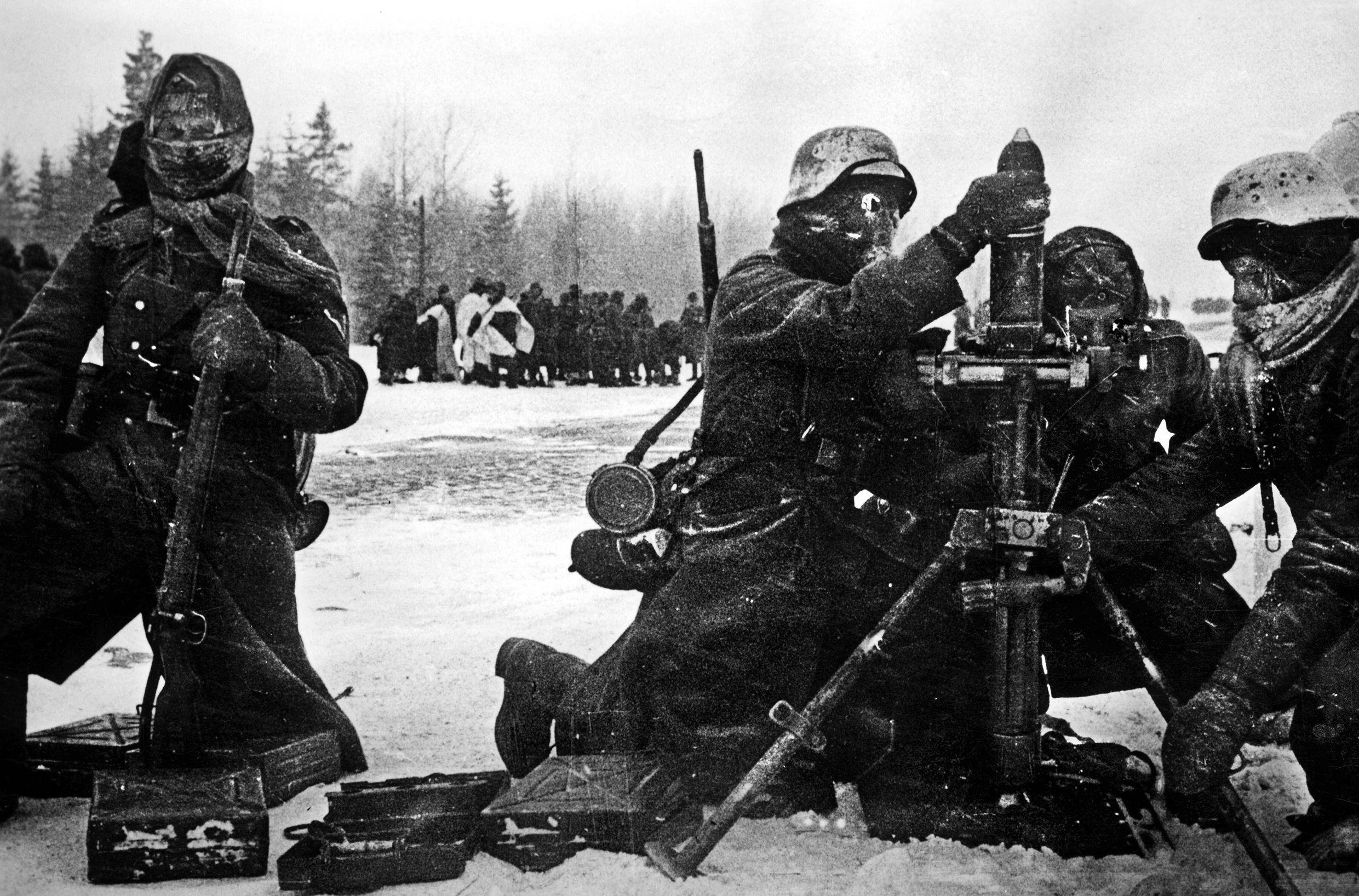A German mortar crew loads their tube in the bitter cold of Vyazma, Russia, in late 1941 or early 1942. With no winter camouflage, some of the men have resorted to painting their helmets white.
