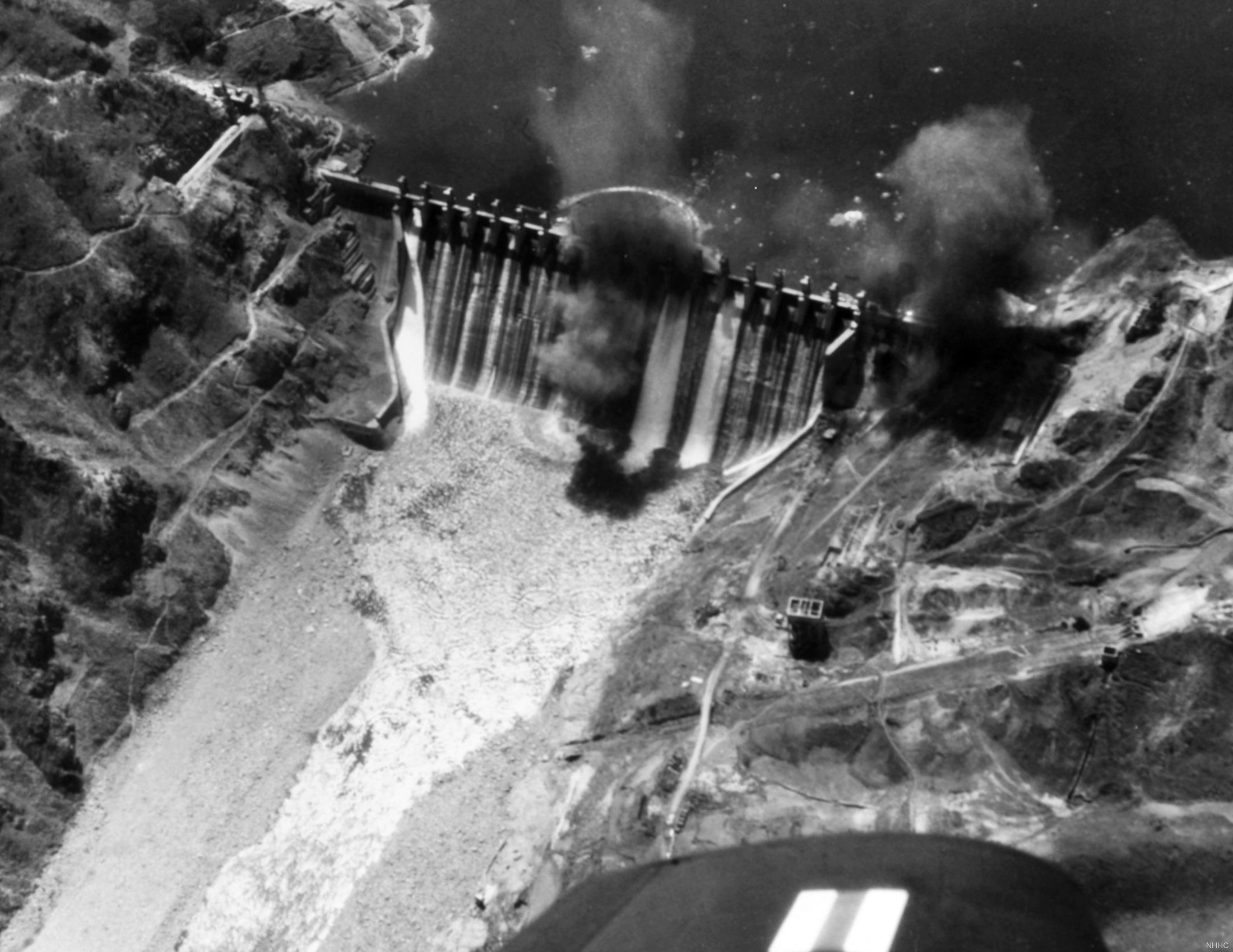 A Grumman F9F-2 Panther photo-reconnaissance jet captured this image of some of the six of eight Mk 13 aerial torpedos striking the Hwachon Dam on May 1, 1951, destroying one sluice gate and heavily damaging others.