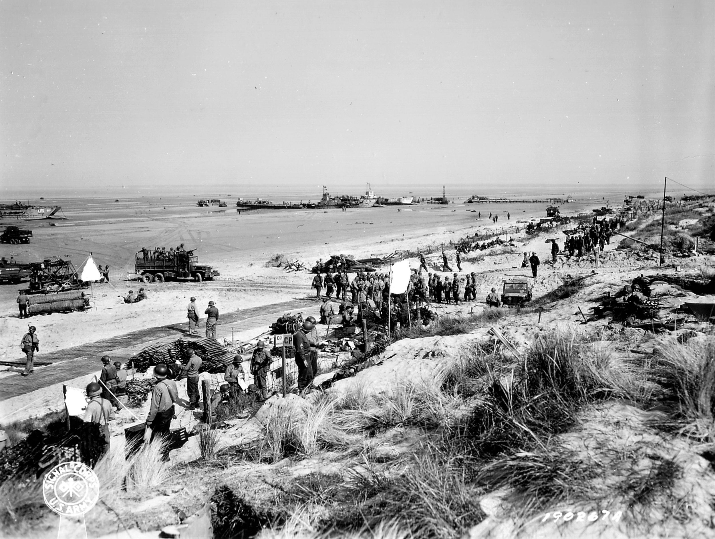 Under constant threat of German artillery and sniper fire, American troops secure a beachhead at Normandy for the massive logistical buildup of men and machines to come. USCG Commander Quentin Walsh and his naval reconnaissance unit landed on June 10 because the capture of the deep-water port of Chergourg was scheduled for D+6, but it was moved to D-20 because more German units had been deployed to the area.