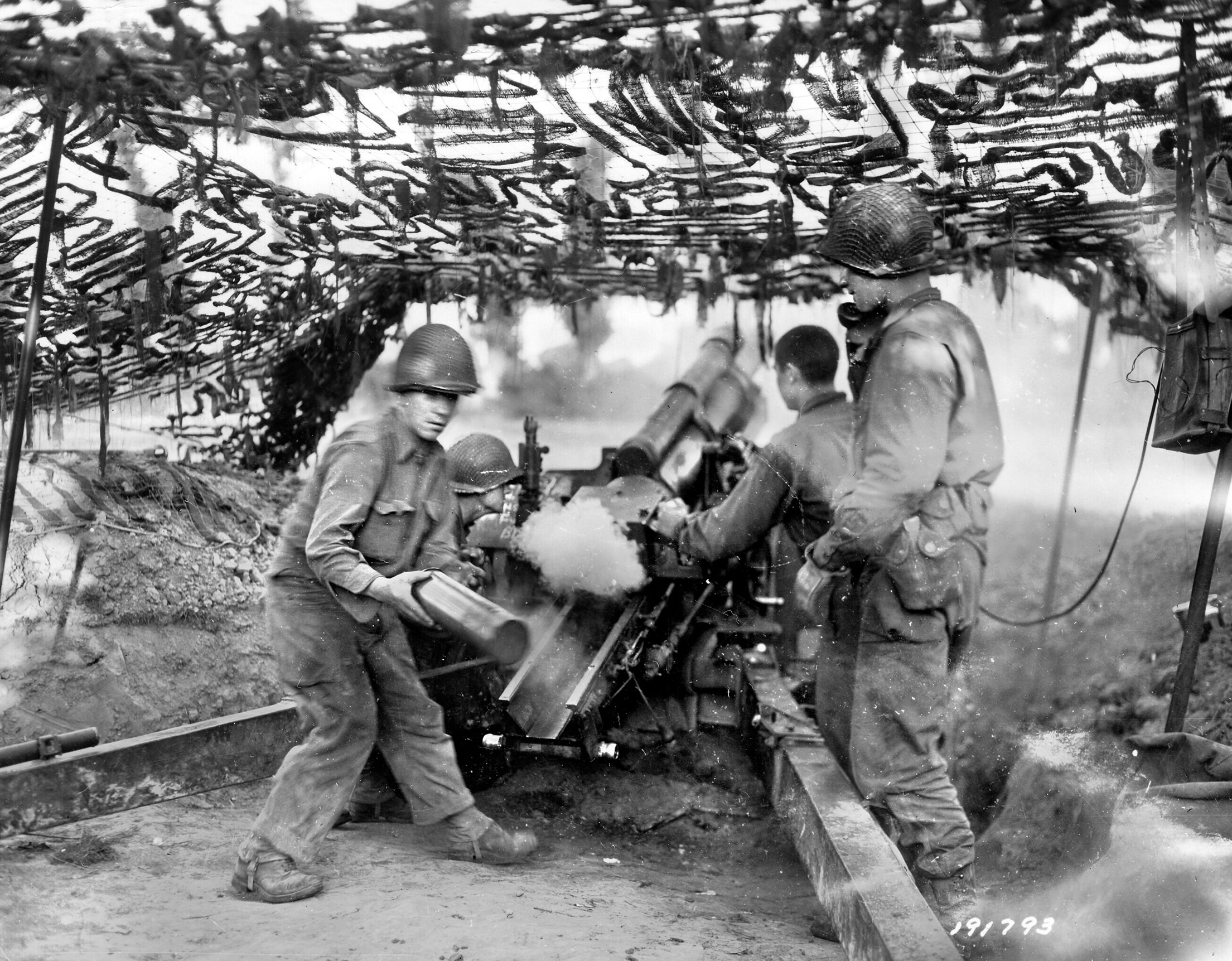 A U.S. Army field artillery unit pours a withering hail of fire on enemy positions in the Saint-Lô sector on July 18, 1944. Rudolf Jackl and his fellow paratroopers endured the artillery bombardment while dug into the hedgerows of the Normandy bocage. 