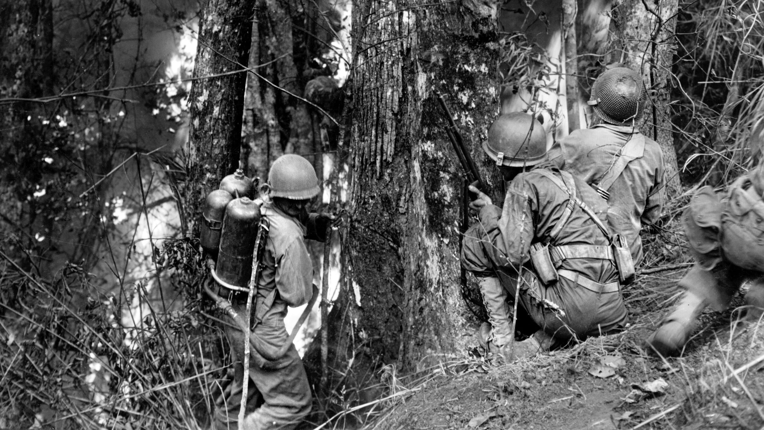 During the 1945 liberation of the Philippines, the 25th Infantry Division faced stiff resistance in the mountains near Baguio. Here, a flame-throwing team works in tandem to shutter a Japanese pillbox during the height of the Luzon campaign.