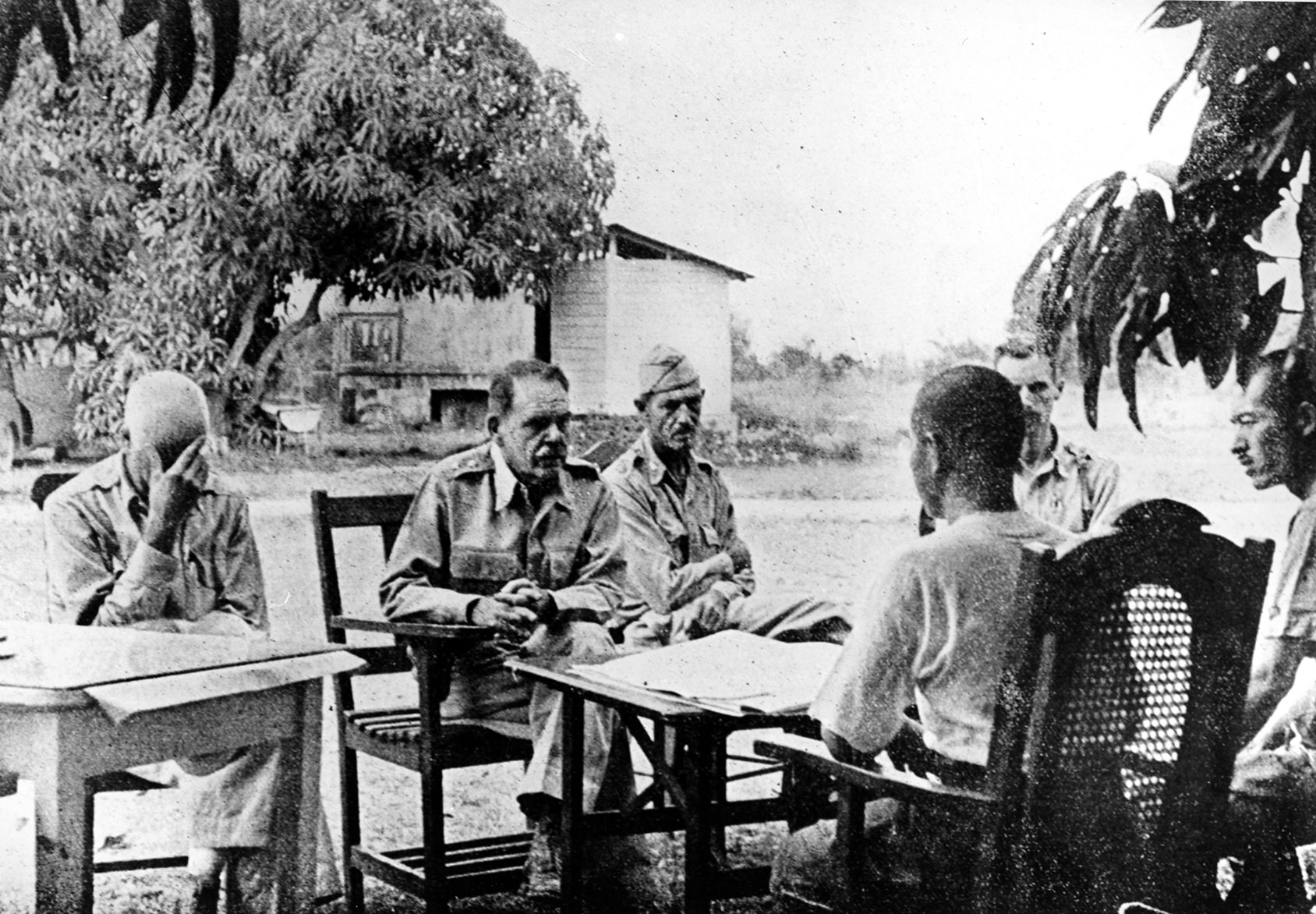 Major General Edward King is interrogated by Japanese officers after the surrender of American and Filipino forces in April 1942. MacArthur received multiple and continuing criticism for his handling of the planned withdrawal to the Bataan Peninsula—he had not adequately prepared the peninsula with stores of food, medicine and ammunition. His miscalculations in planning the retreat led to rapid unorganized movements and the loss of critical supplies. Critics, including some of his own troops, called him “Dugout Doug,” because he rarely visited the front lines during intense fighting. Finally, even though he was ordered to do so by President Roosevelt, MacArthur retreated to Australia, leaving his army to surrender and suffer the Japanese war crime that would become known as the “Bataan Death March.”