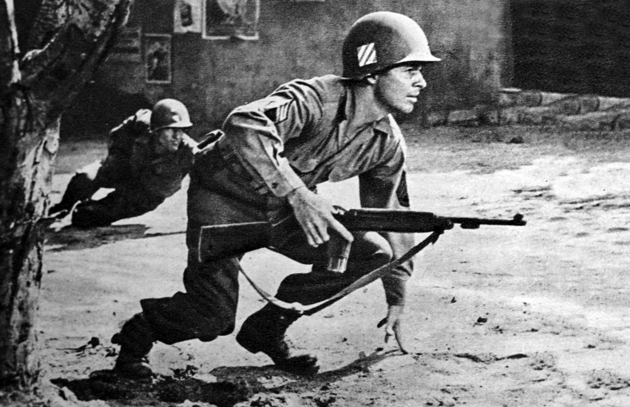 Staff Sergeant Audie Murphy races through the set of a war-torn village in a scene from the the 1955 autobiographical film, To Hell and Back, based on his 1949 memoirs of the same name. Murphy, the most decorated U.S. soldier of World War II earned 33 awards, decorations, and citations—including the Medal of Honor, Distinguished Service Cross, two Silver Stars, Legion of Merit, two Bronze Star Medals (one with a “V” device), three Purple Hearts, a French Legion of Honour and a French Croix de Guerre with silver star—played himself in the film.