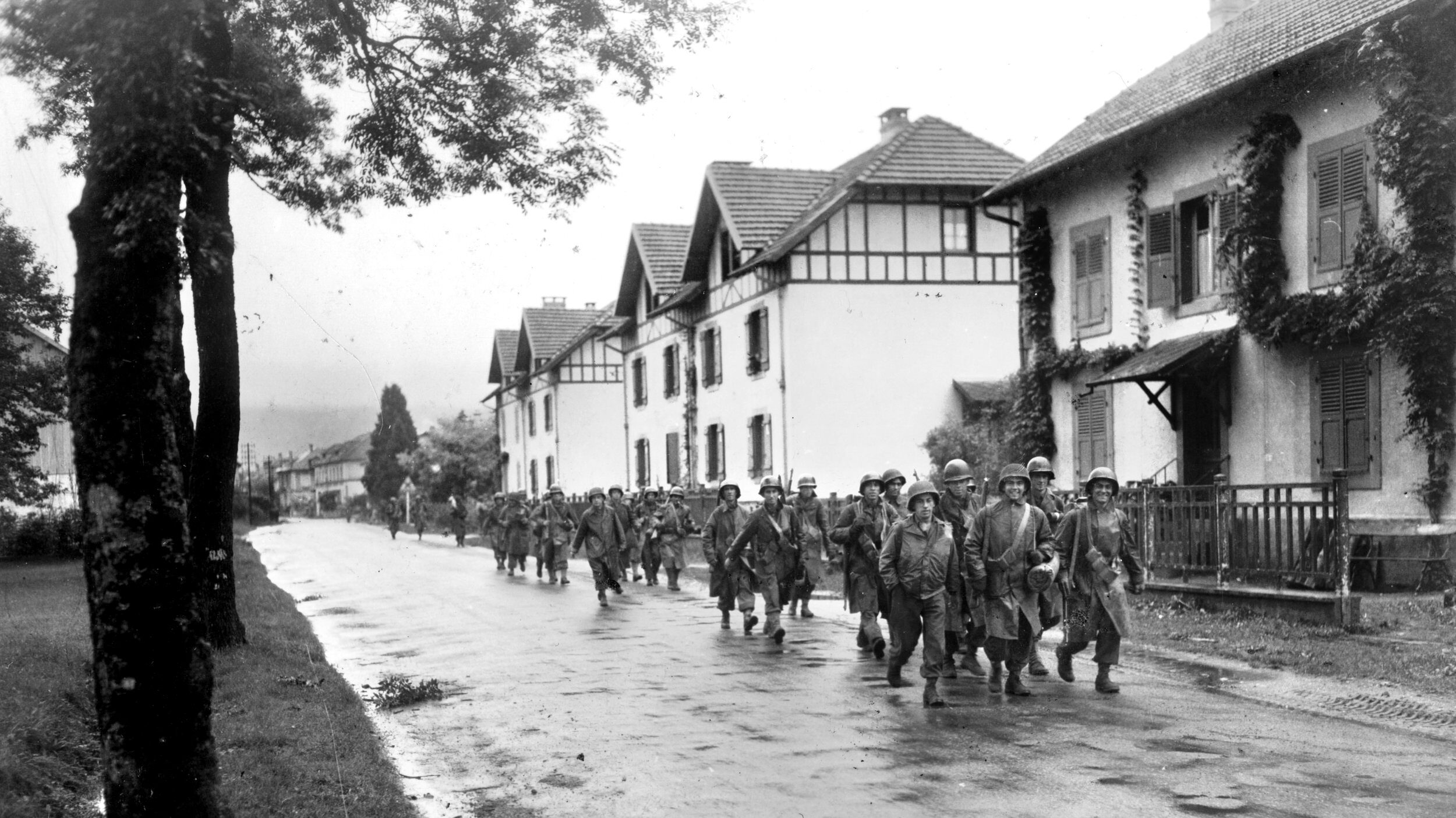 Heavily burdened and drenched by a relentless late-September downpour, infantrymen of Company C, 1st Battalion, 7th Regiment of the 3rd Infantry Division trudge through the village of Rupt-sur-Moselle. After a lightning-fast, 400-mile advance from the Mediterranean beaches of Southern France, the “Rock of the Marne” Division found itself approaching the Vosges Mountains—a fortress of dense pines and granite peaks where the retreating German 19th Army intended to turn the autumn rains and steep terrain into a lethal bottleneck.