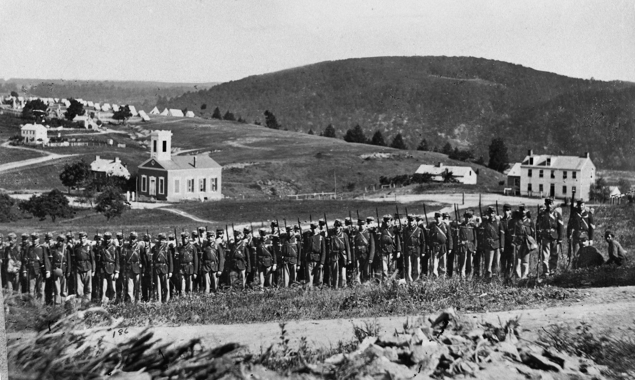 Company A, 22nd New York State Militia, poses for a group photograph near Harpers Ferry. Confederate forces would later seize the arsenal.