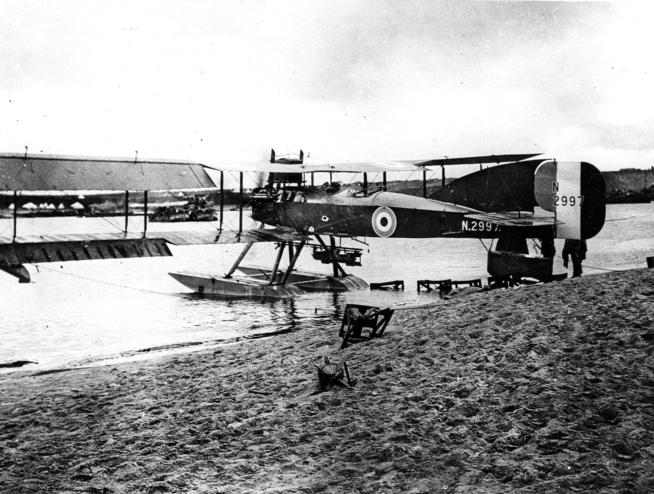A seaplane with extended wings photographed near Gibraltar during WWI. The equal-span wings, with three “bays” (spaces between strut pairs) and tractor engine (as opposed to a rear-mounted pusher engine) makes this most likely a Royal Naval Air Service Short Type 184 Folder, widely used in the war for reconnaissance and bombing. 