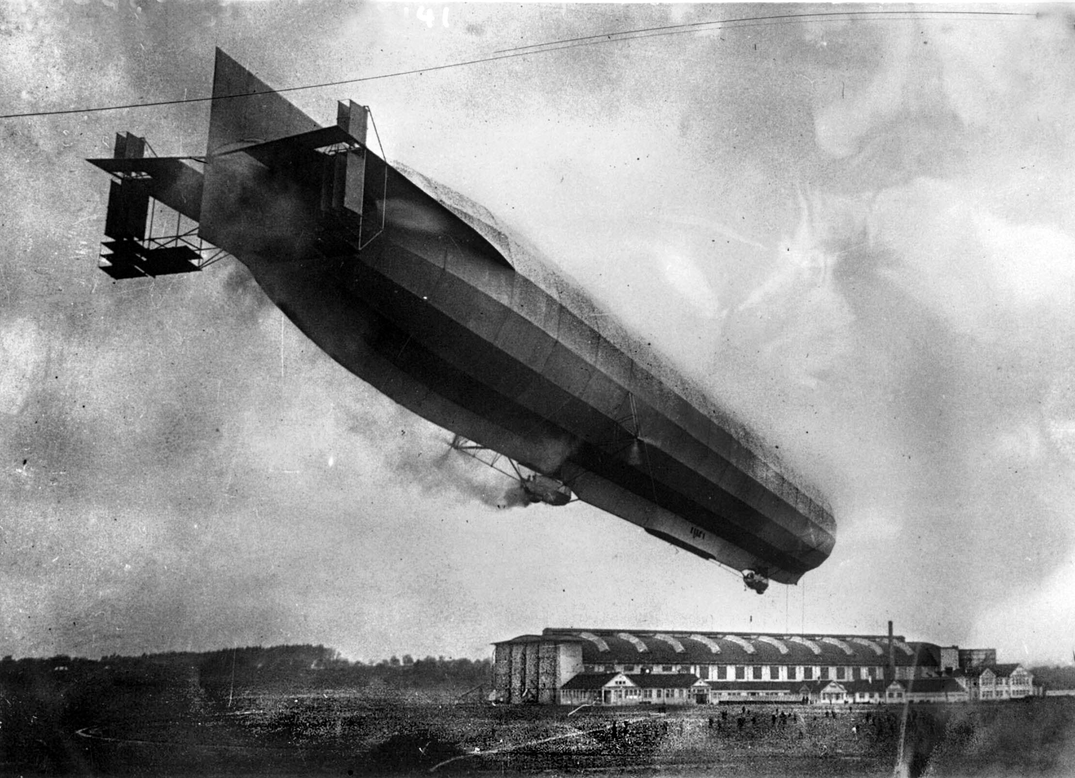 Undated photograph of Zeppelin Z. VIII (LZ 23) over its hangar. On August 21, 1914, while flying low in support of ground troops pursuing retreating French forces, the 511-foot airship was damaged by small arms fire and forced to land in the woods near Badonviller, France. The crew was unable to burn the airship because it had lost so much hydrogen and the wreckage was later displayed as a trophy in Paris. 