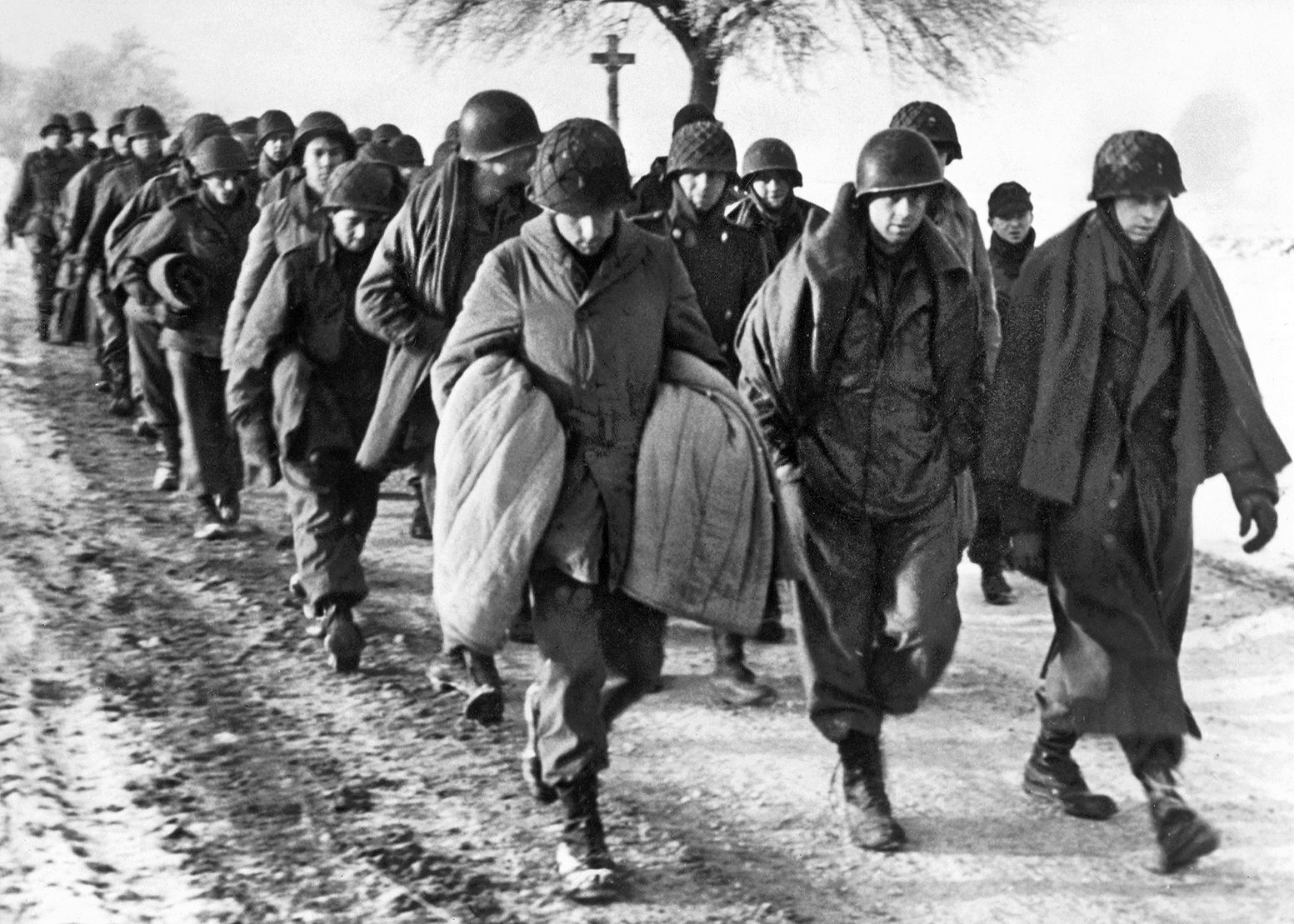 After their legendary stand at Hosingen—stalling the German juggernaut against overwhelming odds—an estimated 300 members of the 110th Infantry Regiment surrendered on December 18, 1944. Their stubborn resistance for nearly three days bought the Allies precious hours to reinforce Bastogne, but for many, it ended in the grim reality of a POW column.
