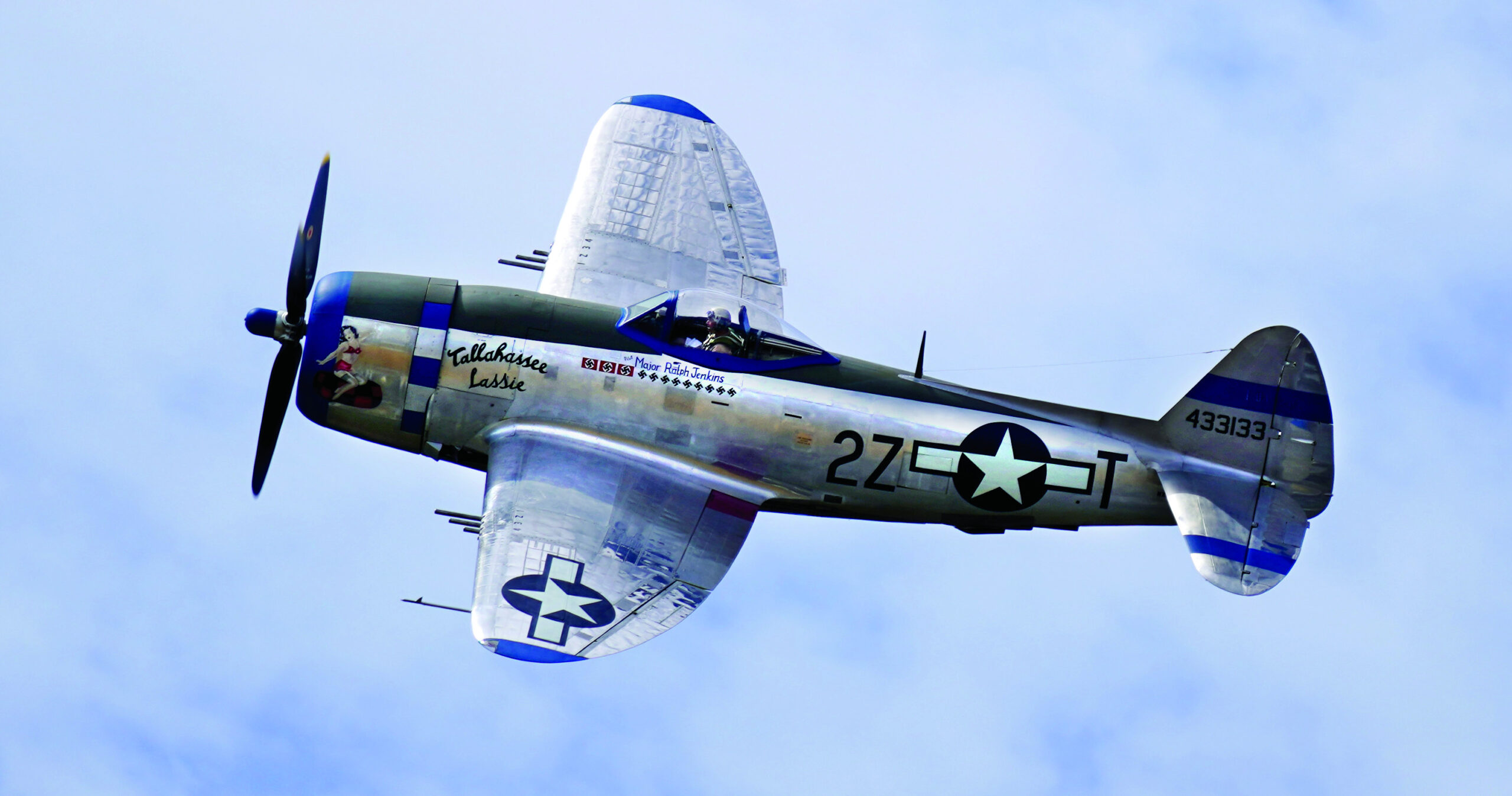 The Flying Heritage & Combat Armor Museum’s rare, airworthy P-47D Thunderbolt Tallahassee Lassie in flight at Paine Field near Everett, Washington, in 2019. The restored “jug” serves as a flying tribute to Col. Ralph C. Jenkins, who led the 510th Fighter Squadron from the hedgerows of France all the way to Germany.