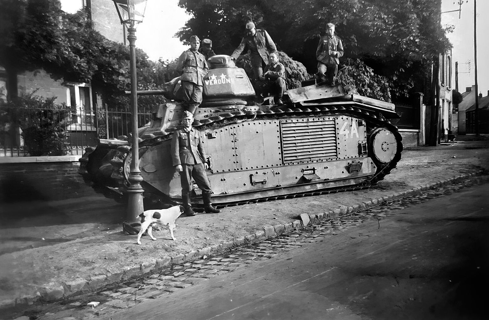 German soldiers pose with the abandoned Char B1 bis Verdun II (hull number 452) during the rapid Axis advance in May 1940. Assigned to the elite 1st Division Cuirassée de Réserve (1st DCr), this 34-ton behemoth was one of dozens of French heavy tanks forced out of the campaign not by German shells, but by an empty fuel tank or a breakdown of its complex powertrain.
