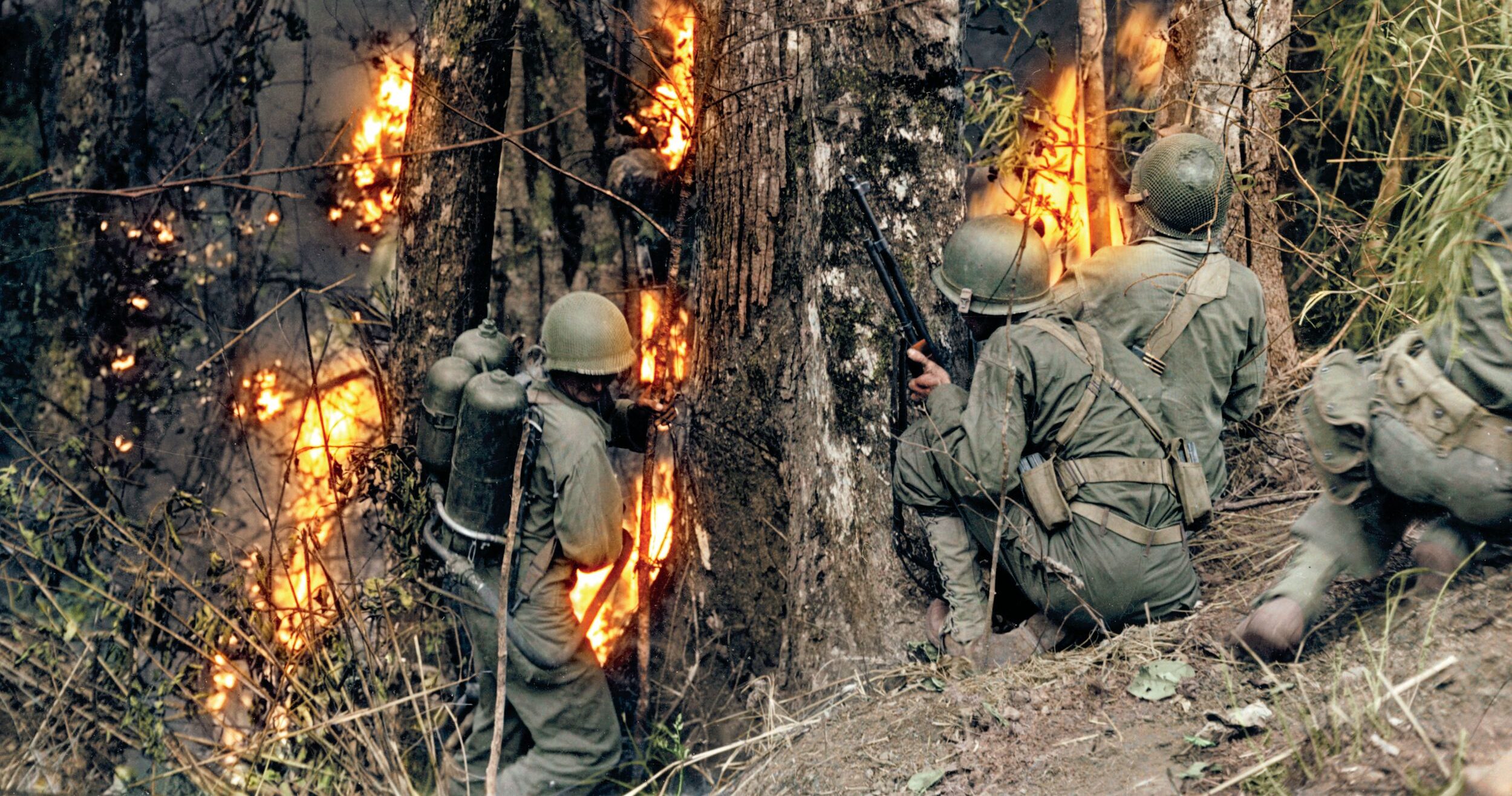 Colorized image of soldiers of the 25th ID advancing on a Japanese pillbox with a flamethrower at Baguto during the 1945 campaign for Luzon.