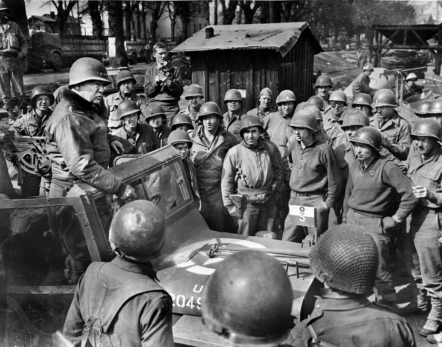 Patton thanks his engineers for their speed in erecting a bridge across the Rhine River, the last natural barrier to invading the Third Reich.