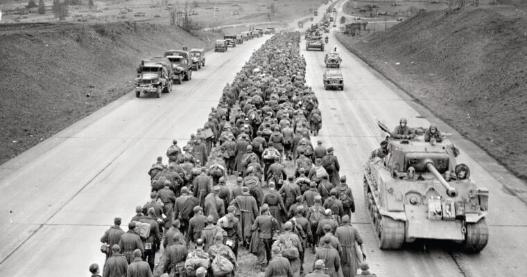 German POWs marching west fill the median of the Autobahn near Giessen as tankers from the U.S. 6th Armored Division roll east. Once across the river, Patton’s army spent the next two months barreling across Germany and would end the war in Austria and Czechoslovakia. OPPOSITE: Patton thanks his engineers for their speed in erecting a bridge across the Rhine River, the last natural barrier to invading the Third Reich.
