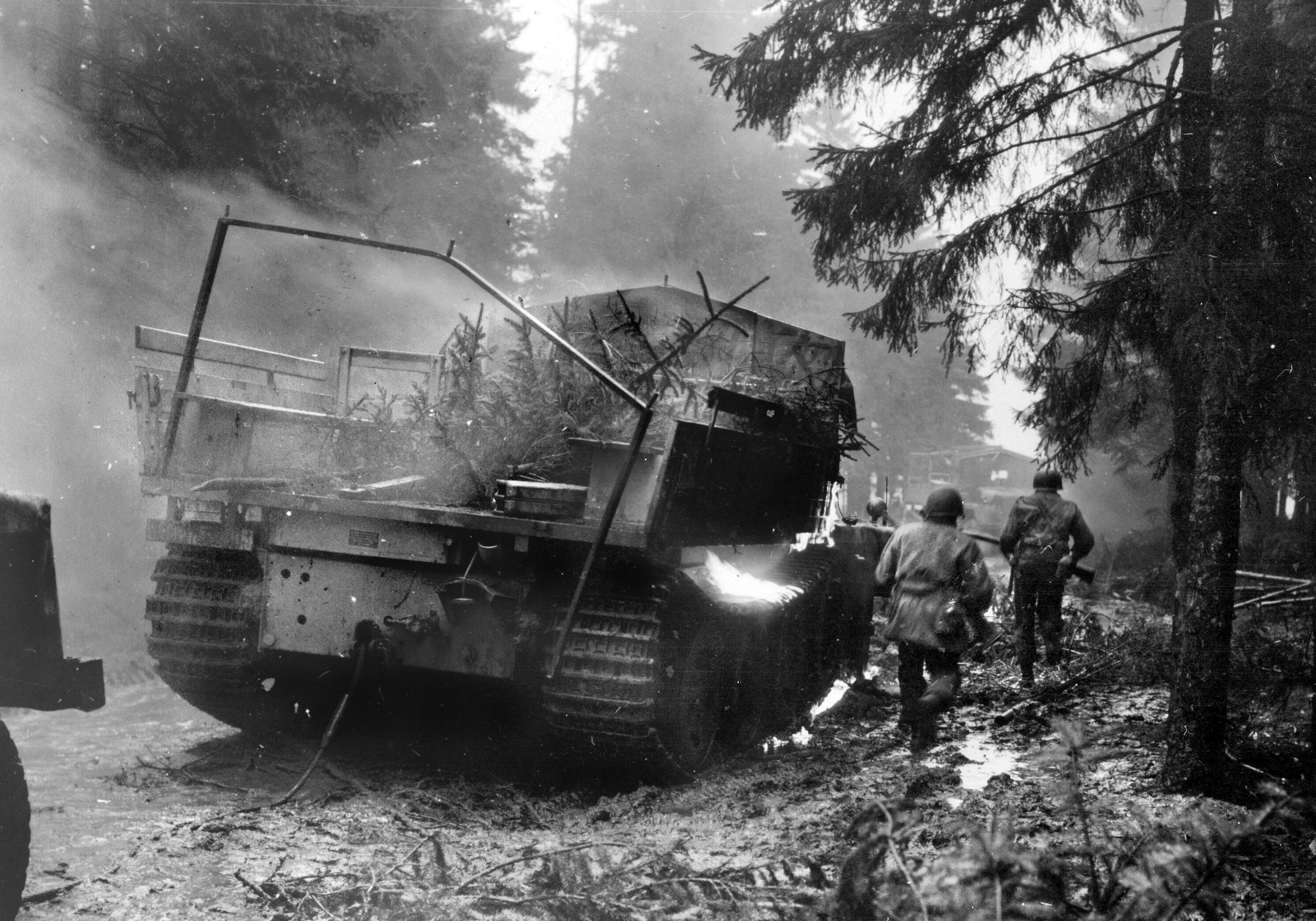 Infantrymen with the 4th Armored Division race past the burning hulk of a German tracked vehicle as they close in on the Rhine River. The 4th was the first of Patton’s divisions to reach this last major obstacle into the German heartland.
