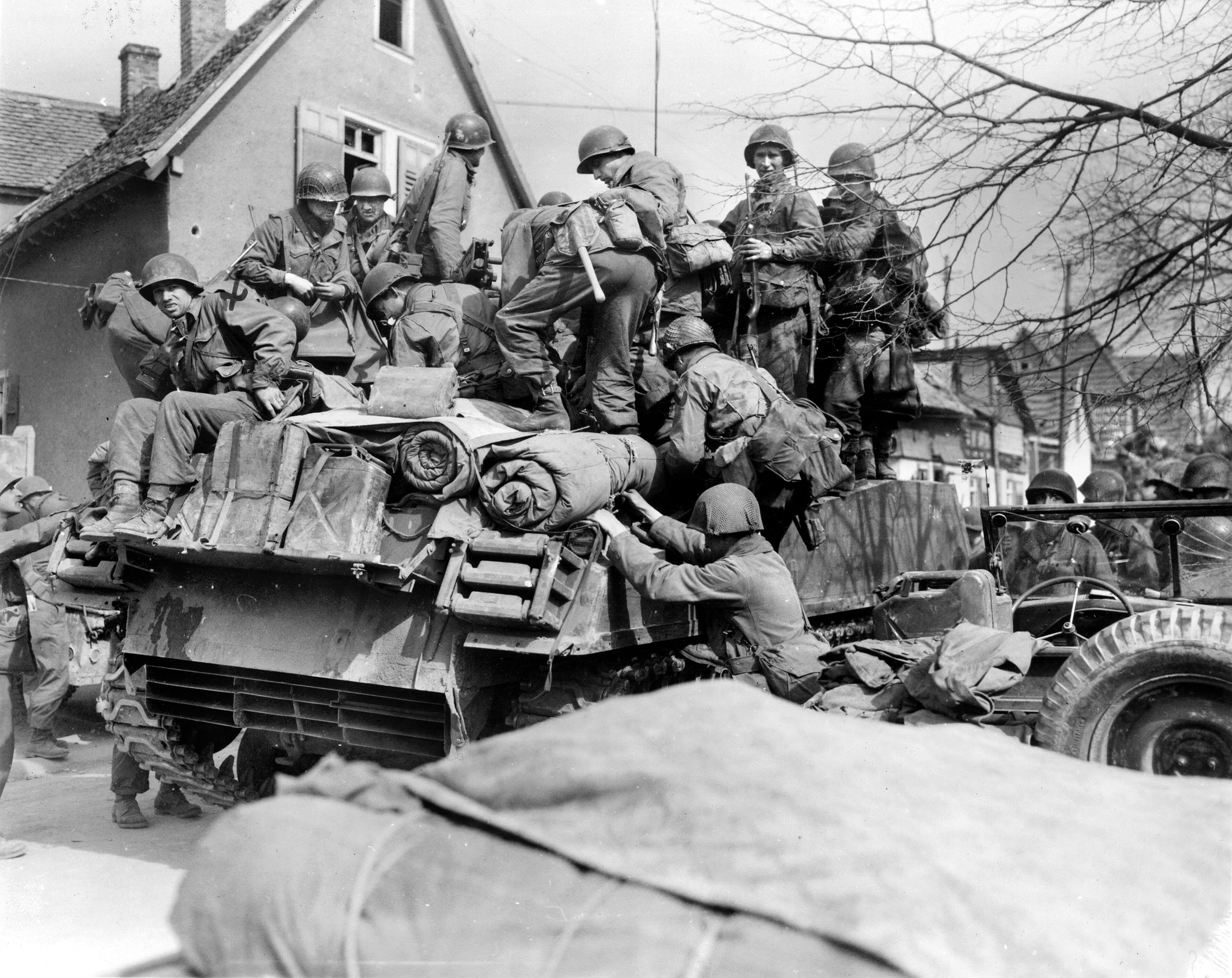 To keep up their momentum, soldiers with the 5th Infantry Division hitch a ride on a tank to meet Patton’s demand that they cross the Rhine as quickly as possible. The 5th would be the first division to cross the river.