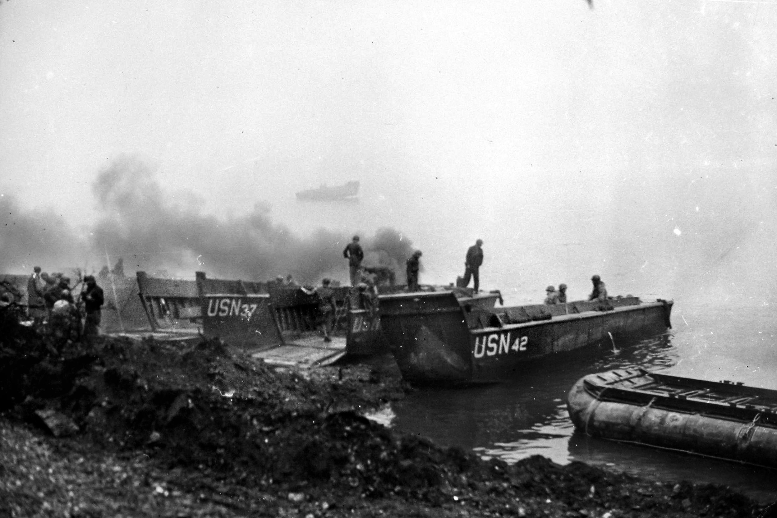 Landing Craft Vehicle Personnel (LCVPs) ferry equipment to the far side of the Rhine. The Navy proved instrumental in support of the Third Army’s river crossing.