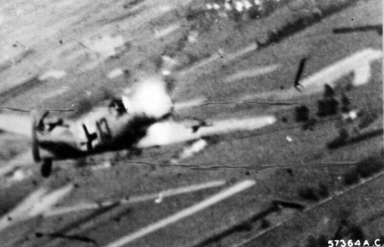 A German Me-109 is “nailed to the ground” by devastating fire from a XIX TAC P-47 Thunderbolt, as captured by the fighter’s wing-mounted gun camera. By late 1944, relentless Allied strafing runs kept German fighters pinned to their hidden woodland strips and concrete runways, turning parked aircraft into defenseless targets for the sweeping American fighter-bombers.
