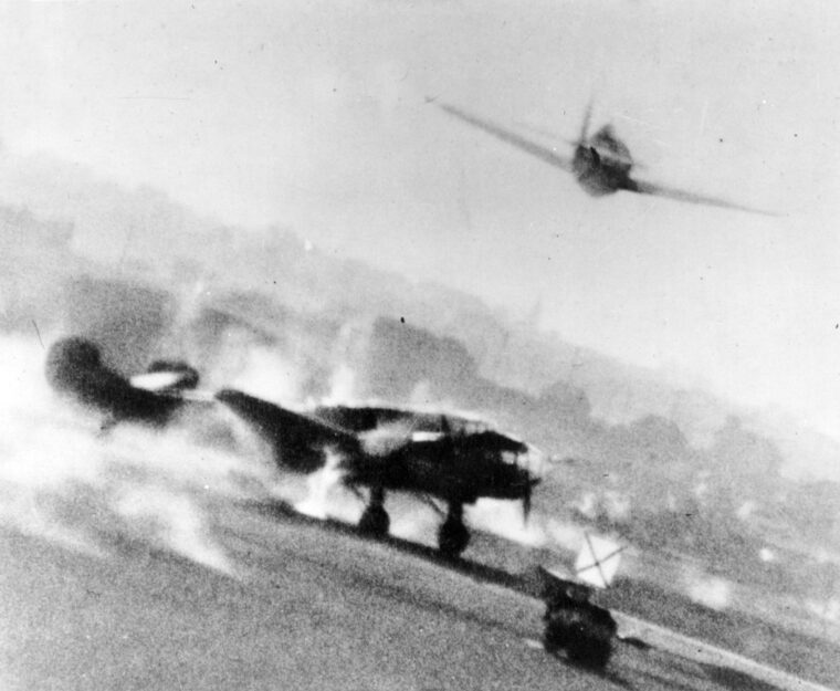 A Ninth Air Force P-47 Thunderbolt targets a German-occupied airfield in France in May 1944, catching a captured French-made Potez 630 twin-engine aircraft on the deck. Secondary aircraft, trainers, and captured prizes like this Potez were heavily targeted to ensure German forces were utterly deprived of transport, scouting, and combat capabilities before the cross-Channel invasion began.