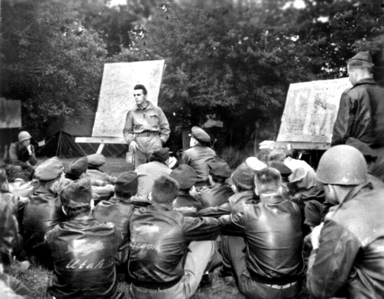Colonel Robert Delashaw, commander of the 405th Fighter Group, outlines tactical targets for an interdiction mission in the summer of 1944. As Allied ground forces launched their breakout from the Norman hedgerows, Delashaw’s fighter-bombers relentlessly swept behind enemy lines to systematically isolate the battlefield and destroy retreating German columns.