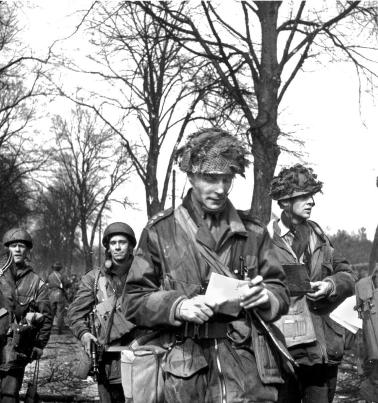 British Brigadier James Hill consults his map during the Allied breakout phase of the Normandy campaign in August 1944. Hill refused evacuation after he was wounded on D-Day and successfully steered his elite 3rd Parachute Brigade—comprising both British and Canadian paratroopers—out of their stagnant defensive bridgehead and into a rapid pursuit of retreating German forces toward the River Seine.