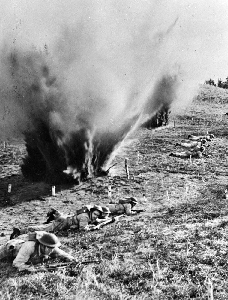 Troopers of the 1st Canadian Parachute Battalion take cover during a realistic simulated attack on England’s Salisbury Plain. Arriving in Britain in the summer of 1943, the Canadians were integrated into the British 6th Airborne Division and subjected to a grueling training regimen—including 18-hour marches of 50 miles carrying a 60-lb. rucksack and weapon—designed to mimic the chaotic, high-stress environments they would encounter in occupied Europe.
