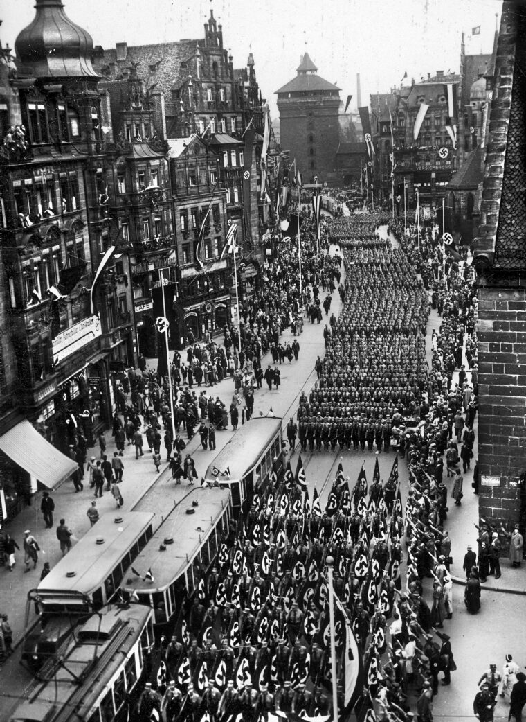 Members of the Nationalsozialistische Deutsche Arbeiterpartei (NSDAP) parade through the streets of Nuremberg during the “Rally of Victory” held August 30–September 3, 1933. The uniformed “brownshirts,” or Sturmabteilung (SA), who served as the party’s enforcers during its rise to power, are prominent among the columns, though they would be violently overshadowed by the rise of the Schutzstaffel (SS) the following year.