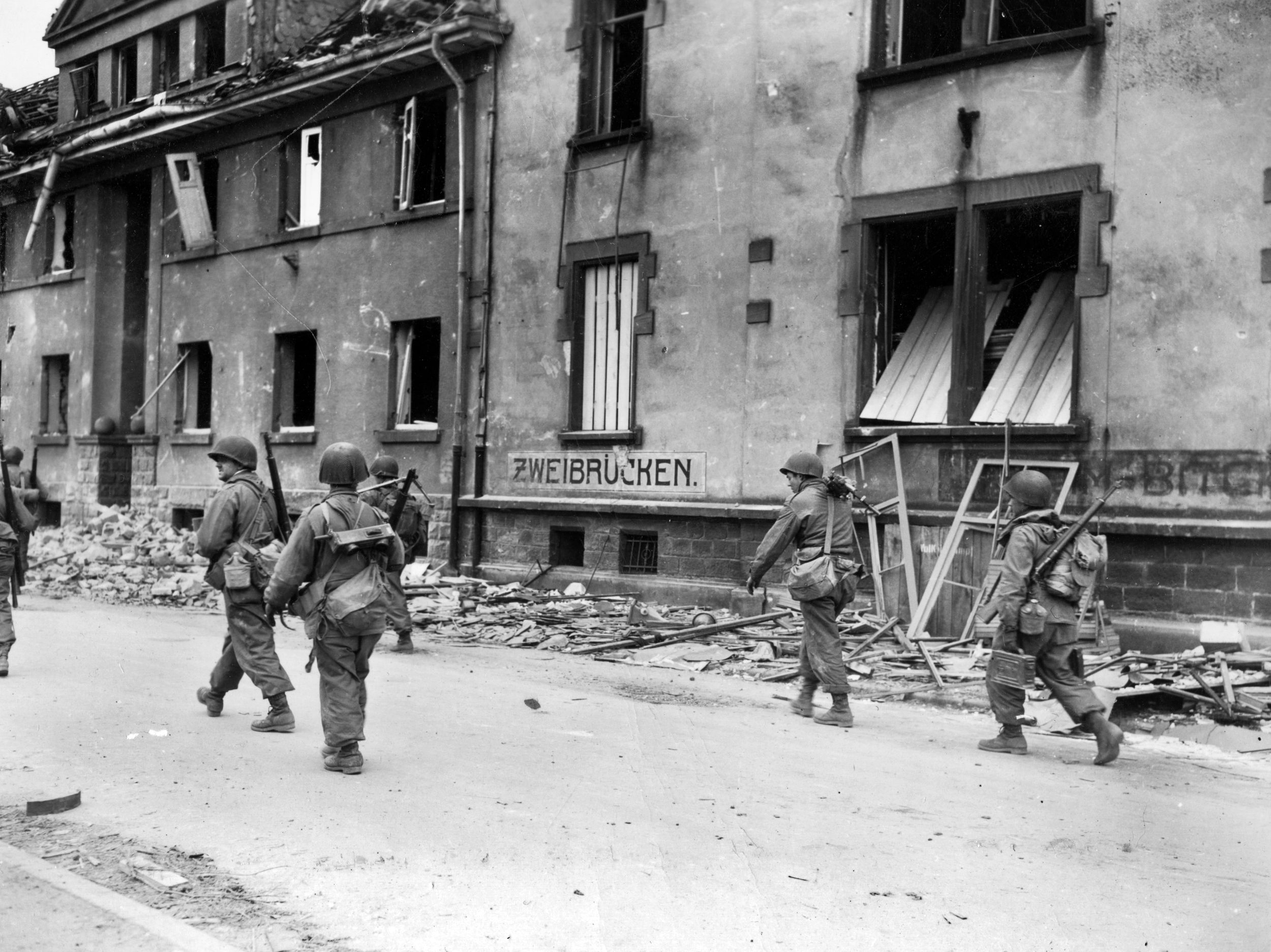 On March 20, 1945, soldiers of the 2nd Battalion, 30th Infantry Regiment—part of the “Rock of the Marne” 3rd Infantry Division that earned more Medals of Honor than any other U.S. division during the war—pick their way through the remains of Zweibrücken, Germany. Once a bastion of the infamous Westwall, the city had been reduced to ruins by Allied air power and artillery.
