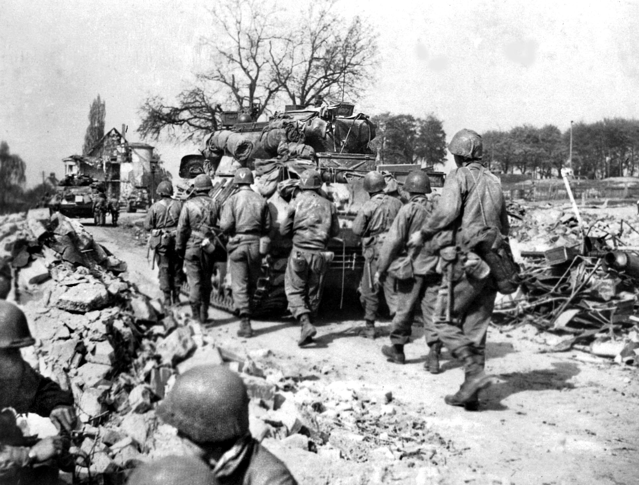 GIs of the U.S. Seventh Army cautiously advance through the remains of Nuremberg in April 1945. The battle for the ideological capital of the Third Reich was a grueling block-by-block struggle, as American infantrymen faced a lethal combination of snipers hidden among the ruins and entrenched German defenders firing from foxholes dug into city parks.