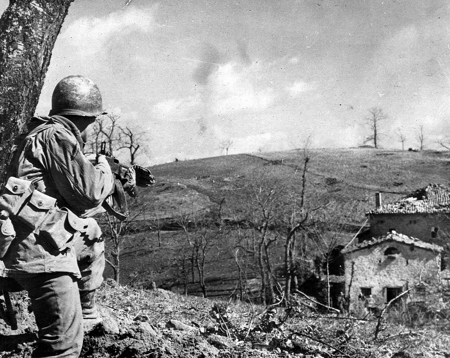After the Allied campaign to penetrate the Gothic Line in the autumn of 1944 failed, the front lay dormant until February 1945, when a new, ultimately successful, offensive began. Here a member of the 10th Mountain Division, which spearheaded the new offensive, covers his buddies approaching a German-held farmhouse.