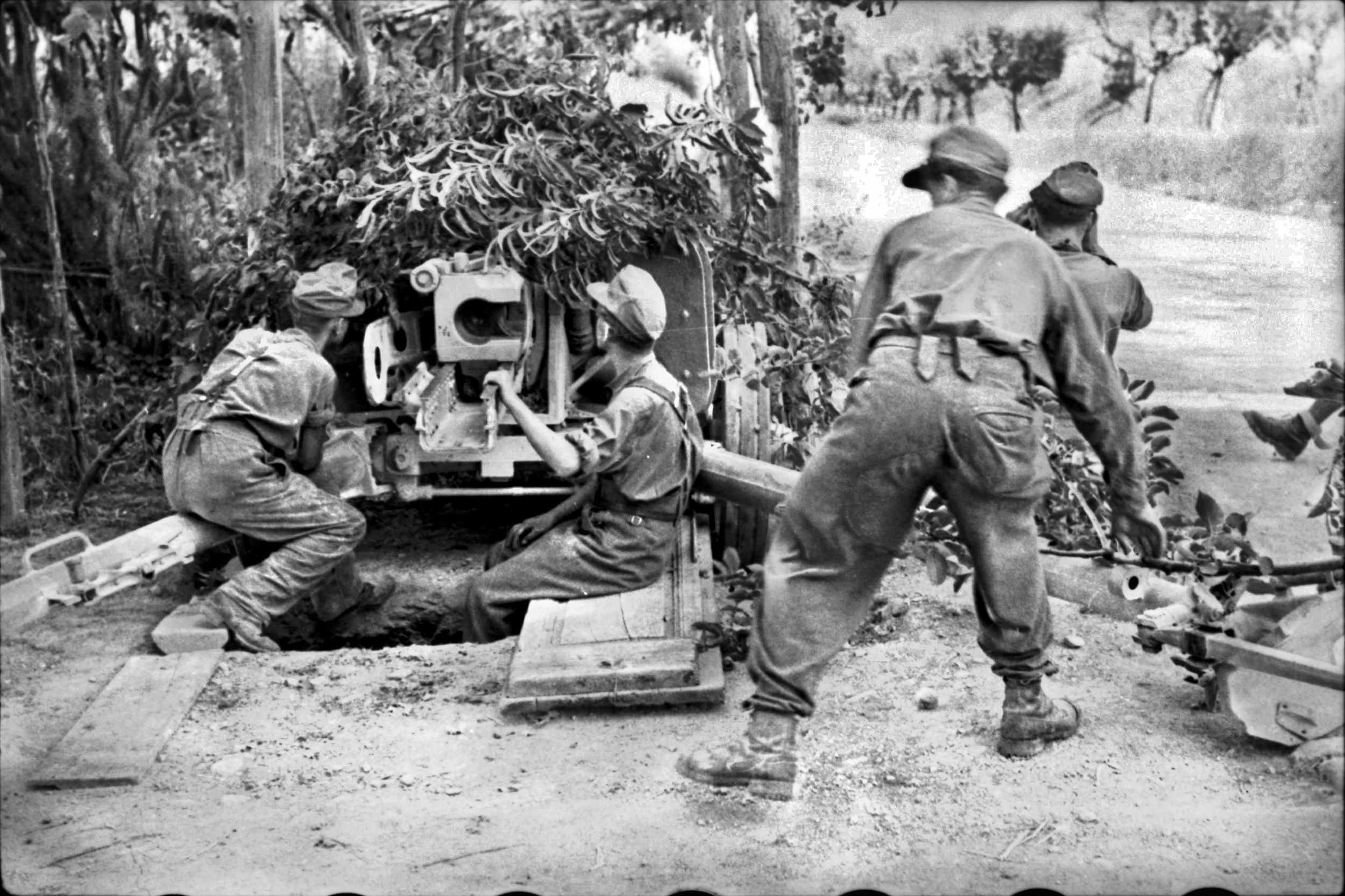 Germans fire an antitank gun at Eighth Army troops near Rimini on the Adriatic coast, September 1944.