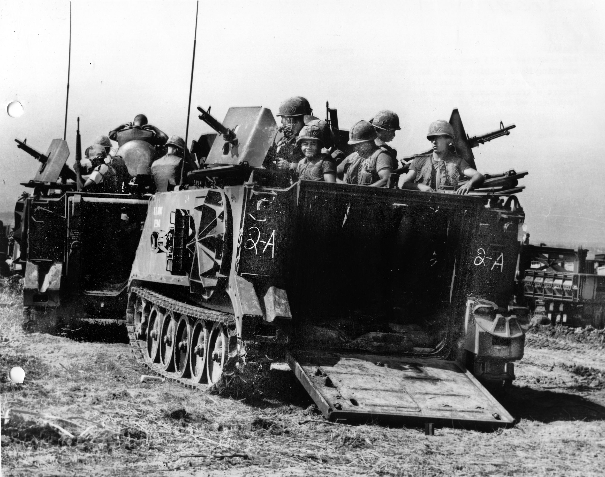 Two M113 Armored Cavalry Assault Vehicles (ACAVs) armed with M60 machine guns escort a supply convoy to the 11th Armored Cavalry Regiment base camp, in September 1966.