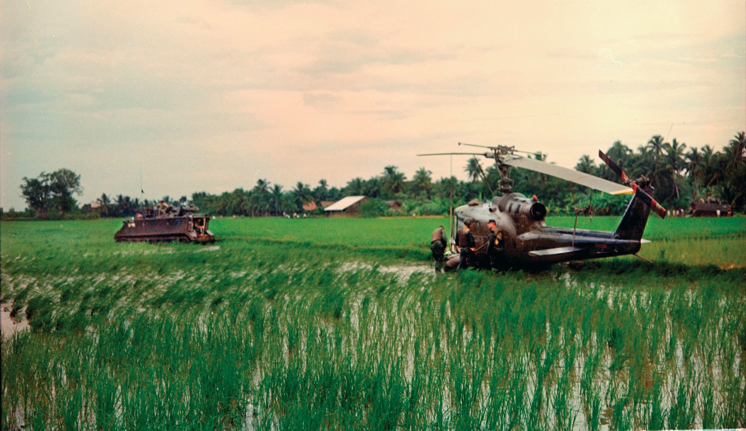 After a UH-1C gunship was shot down in South Vietnam in October 1967, the crash site was secured by a cavalry unit using M113 armored personnel carriers. A CH-47 Chinook later evacuated the damaged aircraft back to its base.