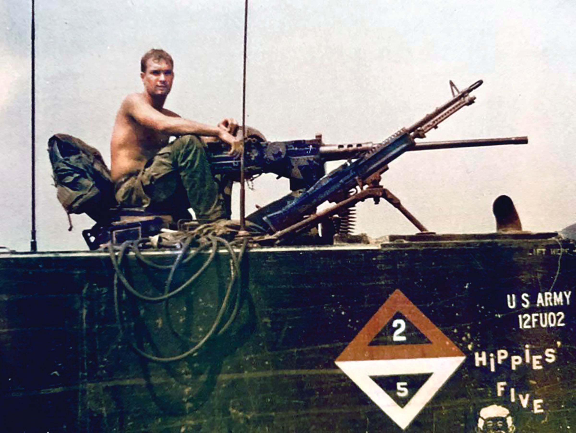 Specialist 4th Class Robert Galyon of 2nd Platoon, H Troop, 17th Cavalry atop M113 Track 2/5 (Hippies Five), circa 1967–1968. Next to an M60 machine gun pointed skyward, Galyon mans a Browning M2 .50-caliber machine gun. These vehicles were later modified by adding gun shields and turrets for protection.