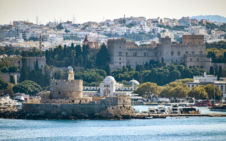 The medieval Palace of the Grand Master of the Knights of Rhodes, now a UNESCO World Heritage Site, overlooks Mandraki harbor, the military port of ancient Rhodes whose entrance could once be closed with massive chains.