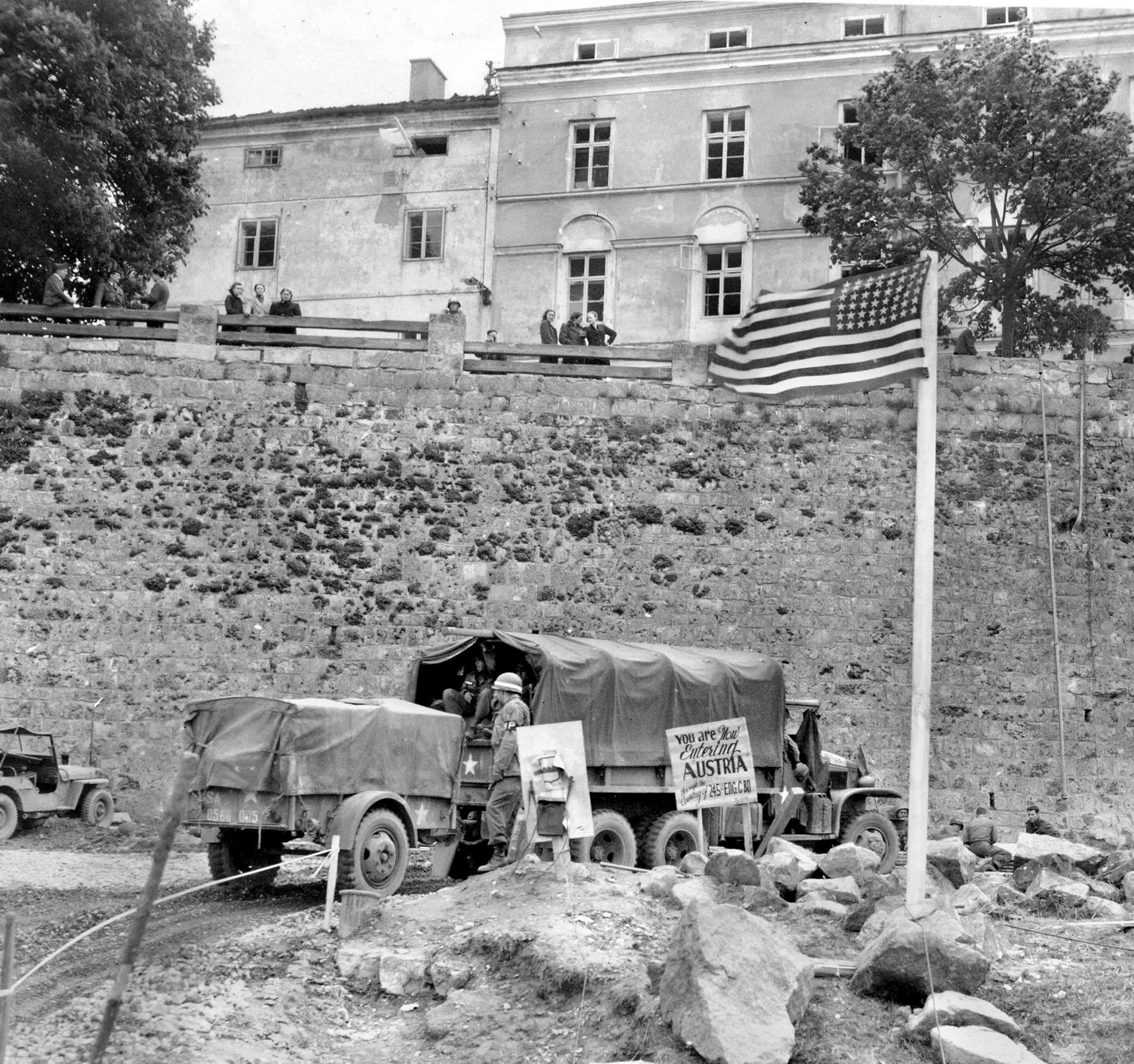 Crossing the Inn River via a heavy pontoon bridge erected by combat engineers, U.S. Army trucks rolled onto the east bank and into Braunau. Behind them on the western shore, engineers had posted a sign that captured the collective relief of Patton’s weary soldiers: “You are NOW leaving Germany, Thank God.”