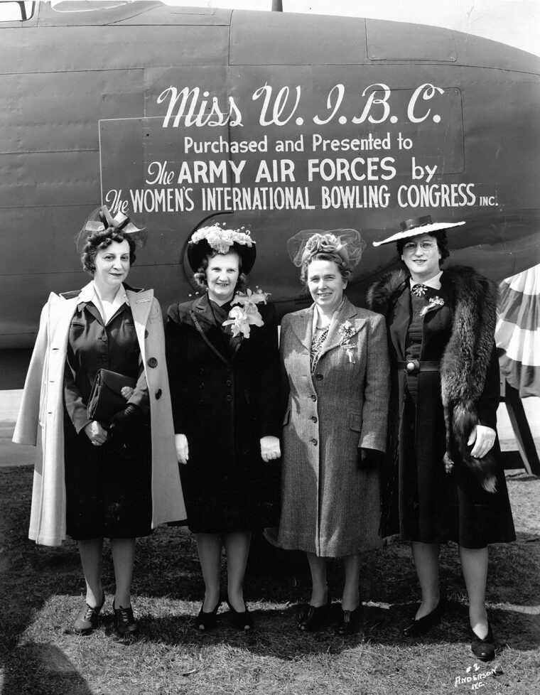 Board members of the Women’s International Bowling Congress (WIBC) gather before Miss W.I.B.C. at Kansas City Municipal Airport on March 28, 1943. Funded entirely through voluntary donations, nickels, dimes, and tournament sweepstakes raised by female bowlers nationwide, the Douglas A-20 “Havoc” light bomber was the first aircraft donated by the organization to the U.S. Army Air Forces. Given a send-off to the strains of “God Bless America,” the presentation launched the WIBC’s broader “Wings of Mercy” campaign, which went on to fund a ground ambulance and three C-47 air ambulance transports by July 1945.