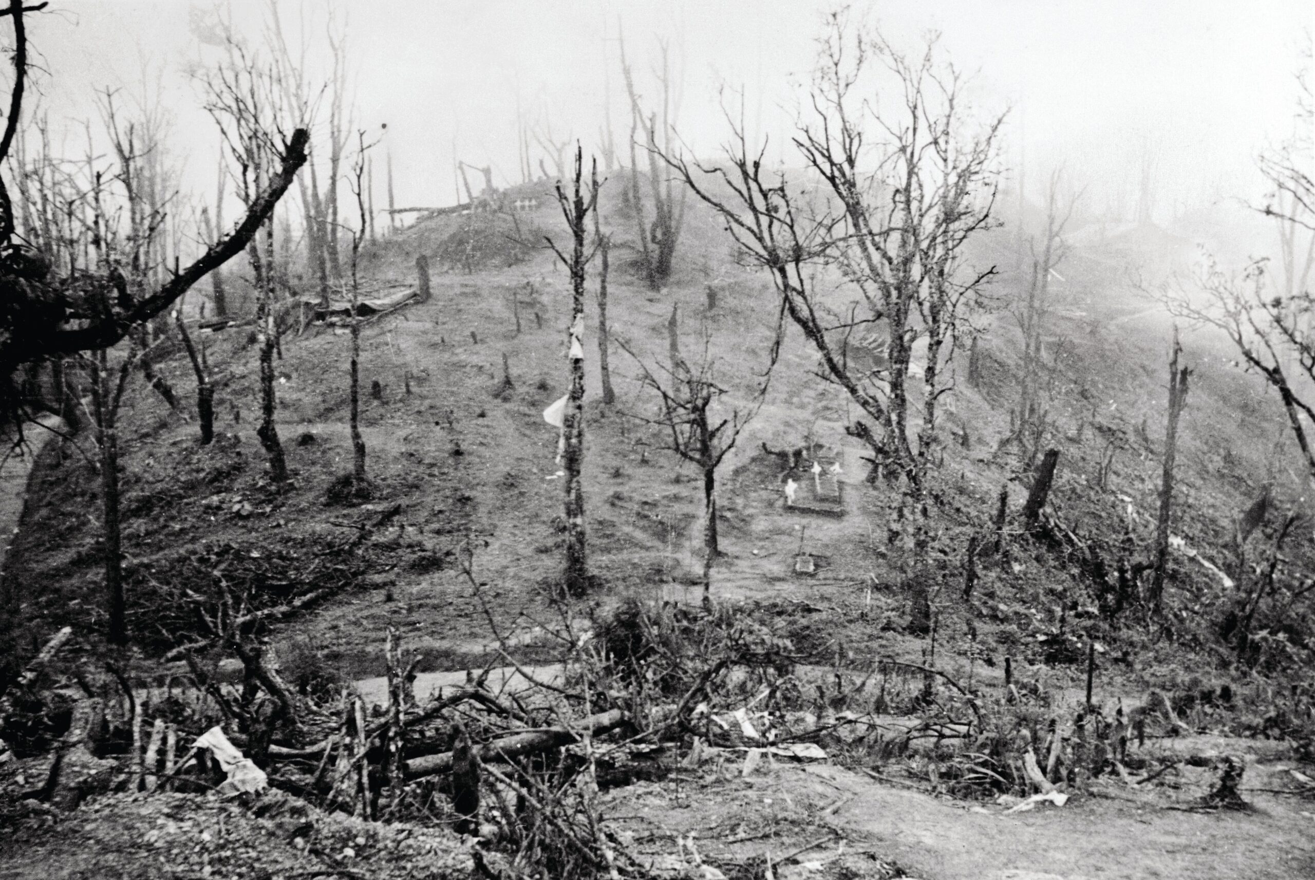 The shattered slopes of Garrison Hill, the linchpin of the British defense during the Battle of Kohima in 1944. Weeks of relentless artillery bombardment, mortar fire, and point-blank infantry combat transformed the once-lush ridge into a cratered wasteland that veteran officers and war correspondents noted bore a resemblance to the Great War’s battlefields of the Somme.