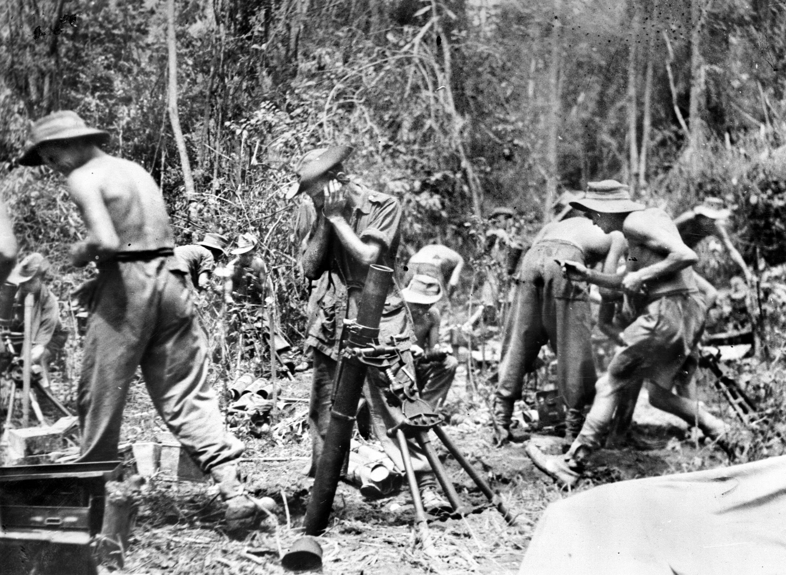 Men of the 2nd Battalion, Royal Norfolk Regiment operate a British 3-inch mortar in support of an Indian Division during the heavy fighting in Assam. Capable of dropping high-explosive shells over steep ridgelines and dense jungle canopy directly into enemy bunkers, these mortars were one of the most effective infantry support weapons of the entire jungle campaign.