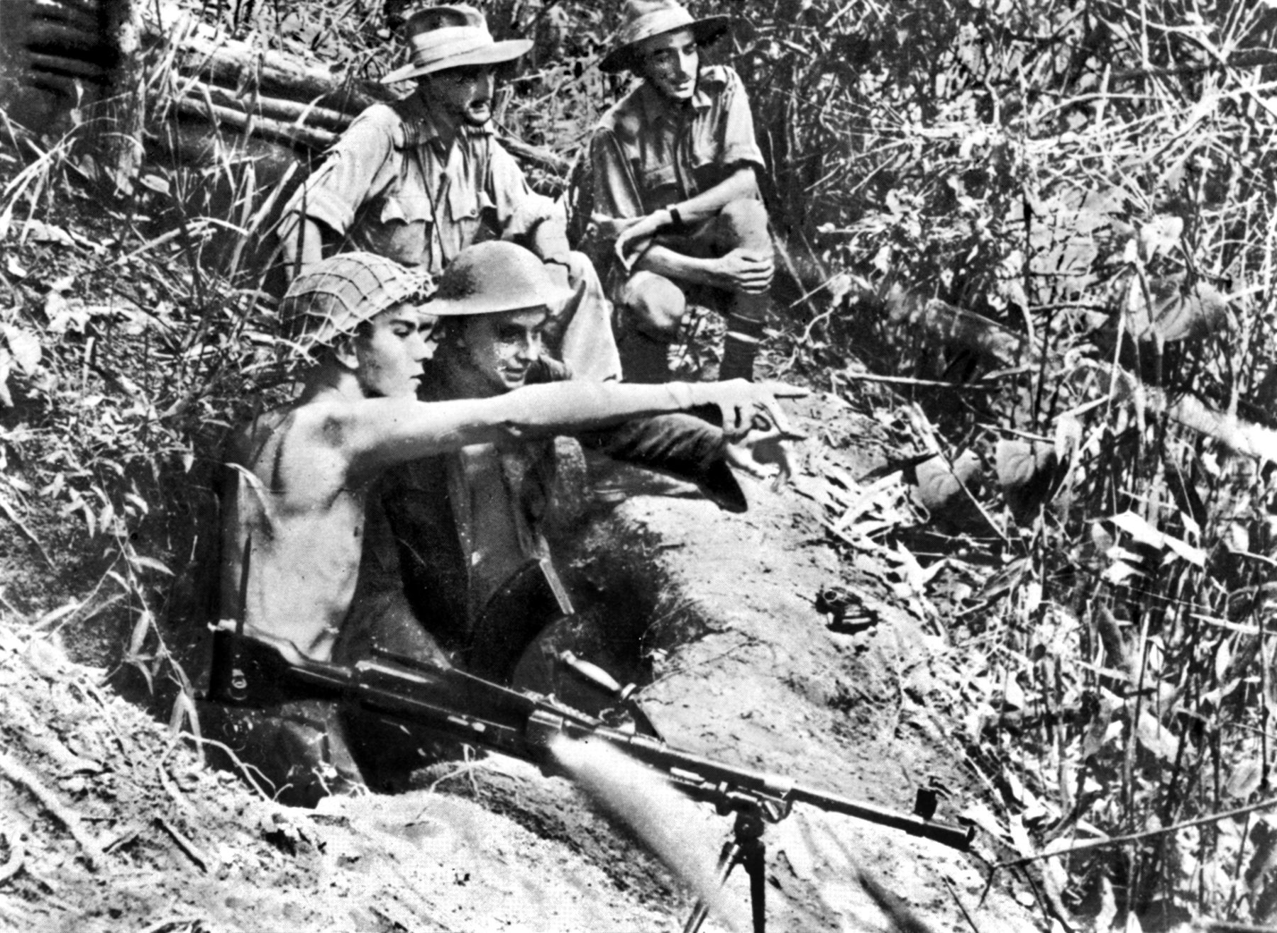 A Royal Air Force (RAF) Bren gun team scans the dense canopy below for signs of enemy movement. Responsible for securing forward airstrips and key logistical hubs, RAF ground personnel frequently established elevated defensive outposts throughout the Far East theater to detect and interdict Japanese infiltration attempts.