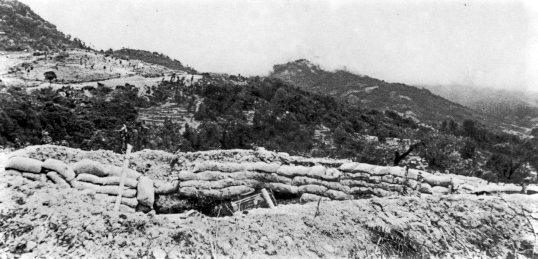 A heavily reinforced British artillery emplacement, lined with sandbags to withstand counter-battery fire, guards the approach near Lancaster Gate in June 1944 as Allied forces press to fully reopen the Dimapur–Imphal road. The defeat at Kohima and Imphal proved catastrophic for the Imperial Japanese Army; of the approximately 85,000 soldiers engaged during their offensive, the Japanese suffered 53,000 casualties—the majority due to Allied firepower, disease, and starvation during their retreat back across the Chindwin River.