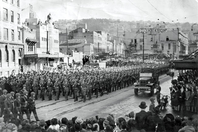 On their way to camps and weeks of intense training, elements of the U.S. 2nd Marine Division march through the streets of Wellington, New Zealand. The American Marines went on to participate in the difficult fighting against the Japanese in the Pacific after leaving an indelible impression on the people of New Zealand.